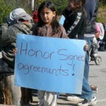 A girl holds a sign during a highway blockade in northern Quebec by the Algonquins of Barriere Lake. Photo: Maya Rolbin-Ghanie